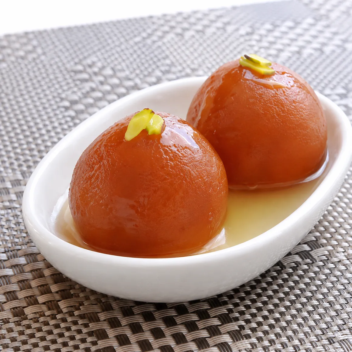 Gulab Jamun — soft milk dumplings in rose cardamom syrup at Saanjh 24-7 Restaurant Winnipeg